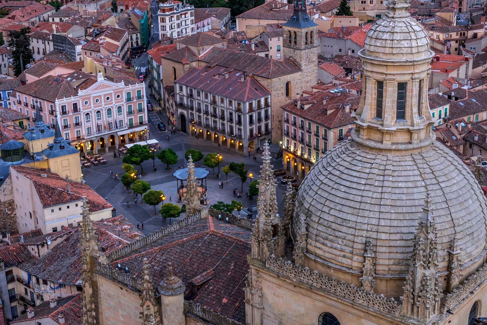 Vista nocturna de la Catedral de Segovia y la Plaza Mayor iluminadas.